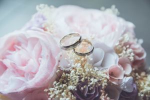 Wedding bands upon a bouquet of flowers